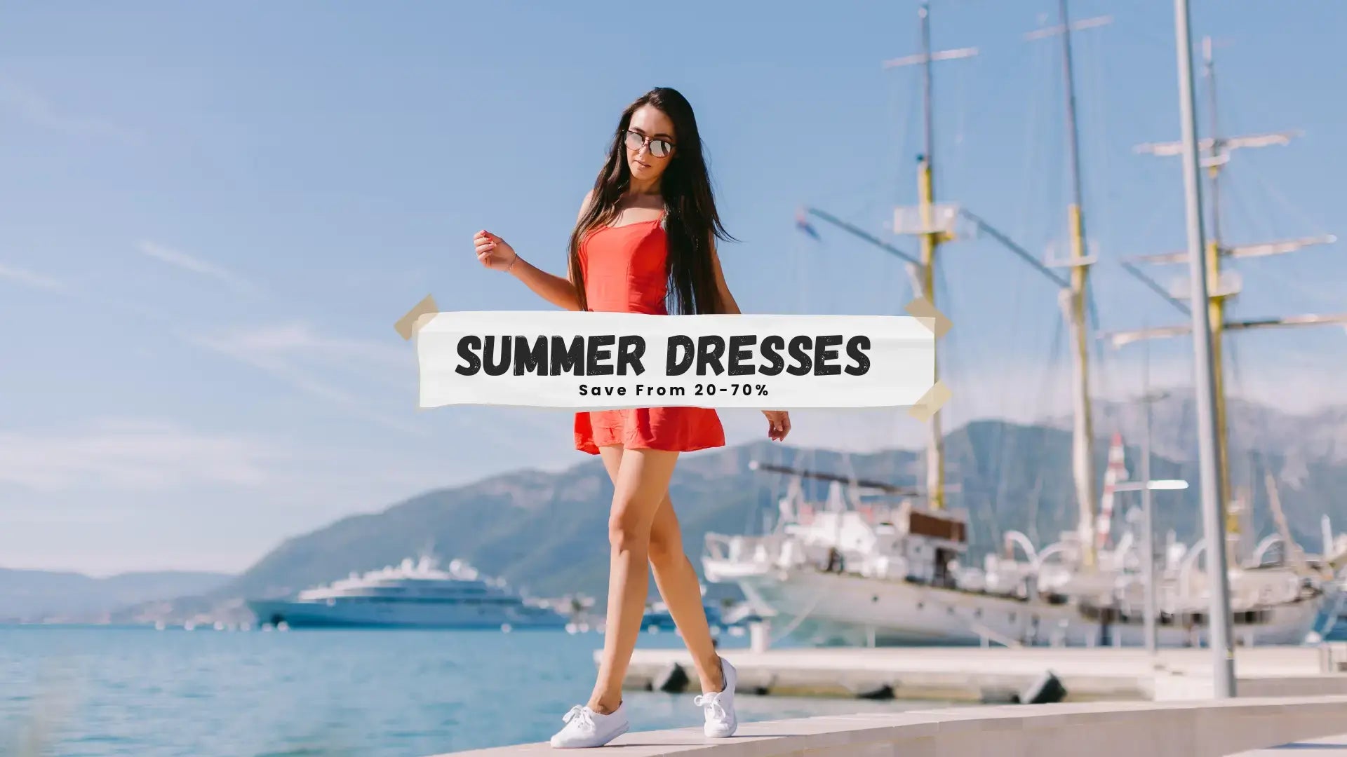 A woman wearing a bright coral-red sleeveless summer dress and white sneakers walks along a waterfront path with boats and mountains in the background. A large banner overlay reads 'SUMMER DRESSES Save From 20-70%'.