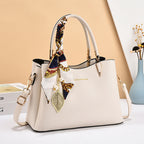 Beige handbag with decorative elements on a light background