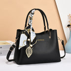 Black handbag with decorative elements on a white surface