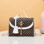 Designer handbag with crown detail on a beige background