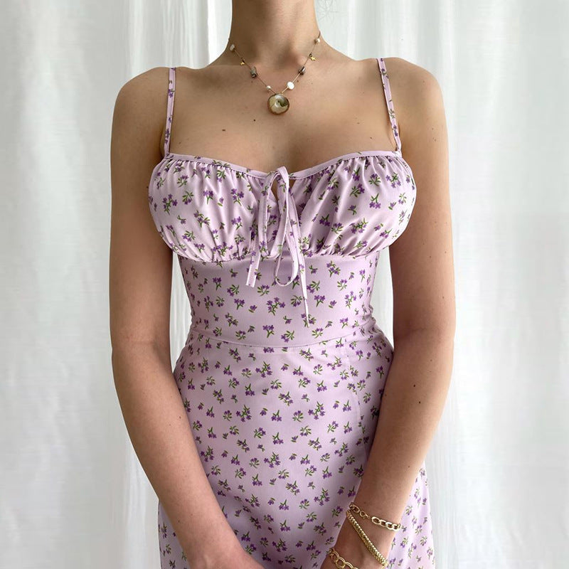 Person wearing a light purple floral dress against a white background