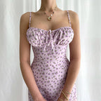 Person wearing a light purple floral dress against a white background