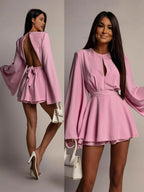 Pink dress with long sleeves shown from front and back on a model against a neutral background