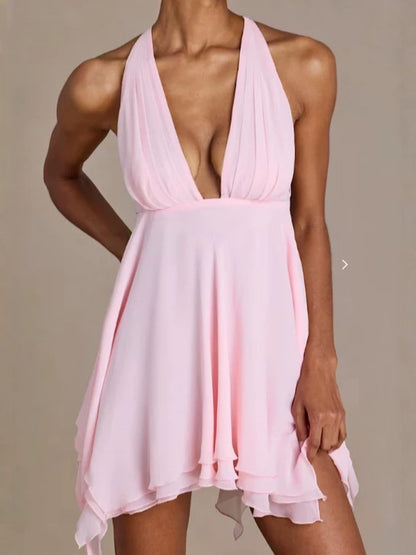 Pink halter neck dress on a neutral background