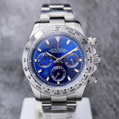 Silver watch with a blue face on a gray background
