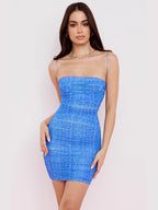 Woman wearing a blue strapless dress against a white background