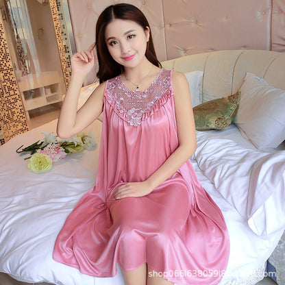 Woman wearing a pink satin nightgown sitting on a bed.