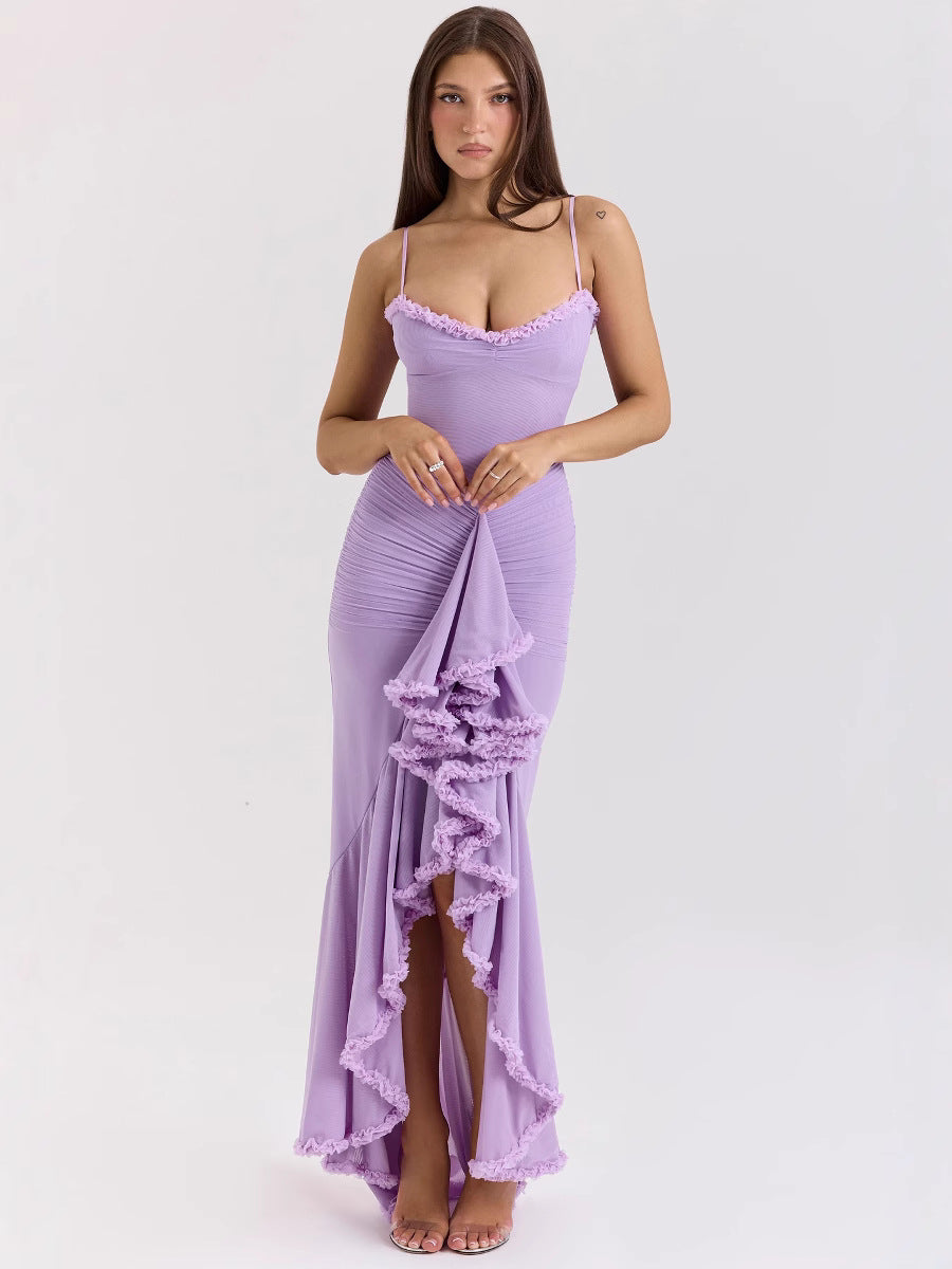 Woman wearing a purple dress with ruffled details on a white background