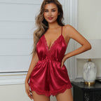 Woman wearing a red satin lingerie set in a bedroom setting