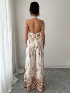 Woman wearing a strapless floral jumpsuit in a minimal indoor setting
